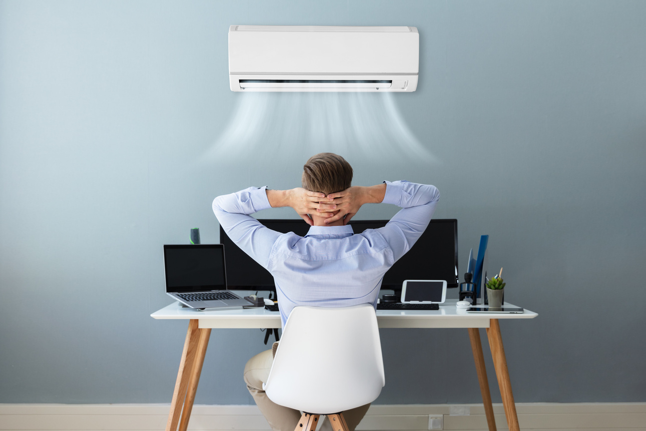 Businessman Relaxing In Office With Air Conditioning