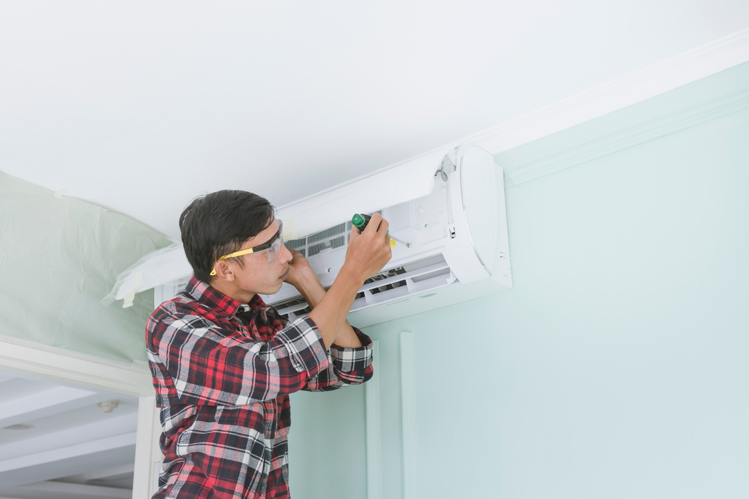 Repairman Fixing an Air Conditioning Unit